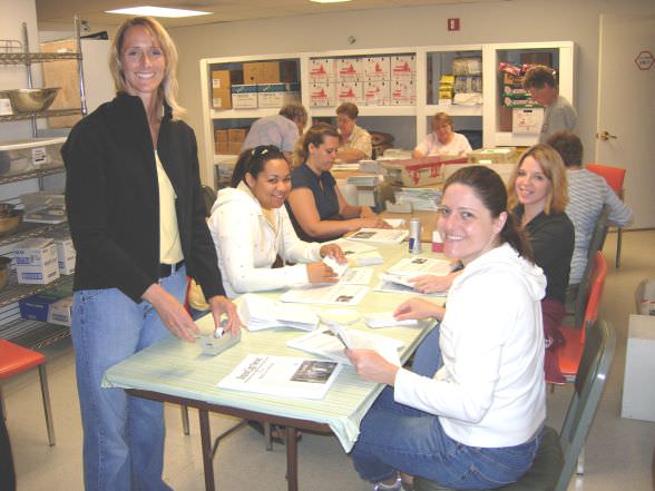Unitus employees Jan Darden, from left, Nicole Spirlin, Summer Hart and April Johnson label SnowCap newsletters; one of many tasks performed by Unitus volunteers during an entire day volunteering.