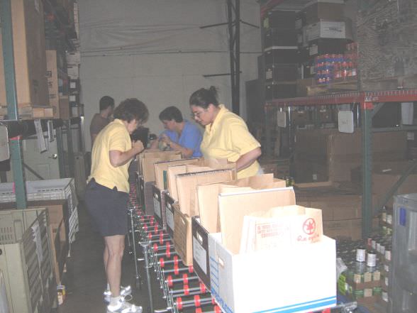 Unitus Community Credit Union employees Linda See, from left, Shelly Keller and Paula Johns pack Food To You boxes during and all day volunteer work session at SnowCap Community Charities headquarters in Mid-county. 